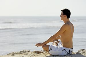 communicating-with-god-man-meditating-on-beach