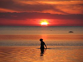 Psychic Healers Assist in Reconnecting You With Your True Self - Woman Bathing in Ocean Sunset